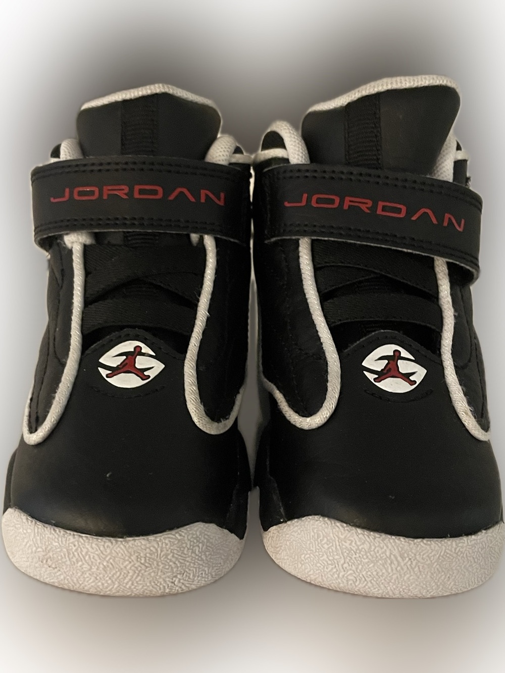 Jordan Black and White Kids Sneakers with Red Logo